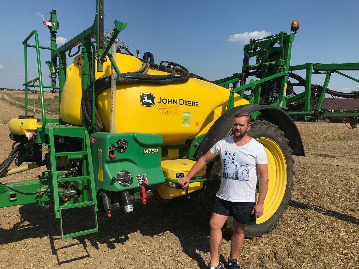 człowiek z maszyną john deere